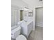 Neutral bathroom featuring a vanity, large mirror, and toilet, and tile floors at 8080 Spanish Oak Dr, Spring Hill, FL 34606