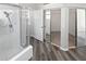 Ensuite bathroom featuring a glass shower, walk-in closet, and modern fixtures at 8080 Spanish Oak Dr, Spring Hill, FL 34606