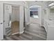 Bathroom featuring walk-in shower, mirrored closet, and backyard pool view at 8080 Spanish Oak Dr, Spring Hill, FL 34606