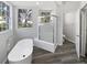 Bright bathroom boasts a glass-enclosed shower, soaking tub, and stylish fixtures at 8080 Spanish Oak Dr, Spring Hill, FL 34606