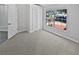 Bedroom featuring neutral carpet, closet, and large windows providing plenty of light at 8080 Spanish Oak Dr, Spring Hill, FL 34606