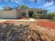 Charming single-story home featuring a well-maintained lawn, inviting entrance, and attached two-car garage at 8080 Spanish Oak Dr, Spring Hill, FL 34606