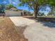 Exterior of home with large driveway and landscaping at 8080 Spanish Oak Dr, Spring Hill, FL 34606