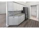 Kitchen with updated cabinets, granite countertops, stainless steel refrigerator and wood-look floors at 8080 Spanish Oak Dr, Spring Hill, FL 34606