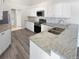 Updated kitchen featuring granite countertops, stainless steel appliances, and modern cabinetry at 8080 Spanish Oak Dr, Spring Hill, FL 34606