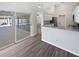 Open concept kitchen with stainless steel appliances, wood floors, and a view of the screened patio and pool at 8080 Spanish Oak Dr, Spring Hill, FL 34606