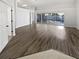 Living room with wood floors and sliding glass doors to the backyard at 8080 Spanish Oak Dr, Spring Hill, FL 34606