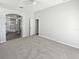Spacious main bedroom with neutral walls, plush carpeting, and an en-suite bathroom at 8080 Spanish Oak Dr, Spring Hill, FL 34606