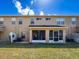 Back exterior of home featuring a screened in back porch and nice grassy yard at 11805 Castine St, New Port Richey, FL 34654