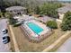 Aerial view of the community pool, with lounge chairs and landscaping at 11805 Castine St, New Port Richey, FL 34654