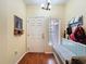 Welcoming entryway with hardwood floors, coat rack and a window providing natural light at 11805 Castine St, New Port Richey, FL 34654