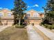Inviting townhome community with manicured lawns, mature trees, and convenient garage parking at 11805 Castine St, New Port Richey, FL 34654