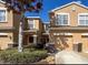 Charming townhome featuring a tan facade, stone accents, and a well-maintained front yard at 11805 Castine St, New Port Richey, FL 34654