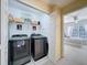 Well-organized laundry room with modern washer and dryer units at 11805 Castine St, New Port Richey, FL 34654