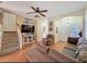 Inviting living room with a ceiling fan, staircase, and entertainment center with a TV at 11805 Castine St, New Port Richey, FL 34654