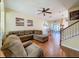 Cozy living room with hardwood floors, large sectional sofa, and staircase at 11805 Castine St, New Port Richey, FL 34654