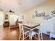 Inviting living space with wood floors, dining table, ceiling fan, and comfortable seating at 11805 Castine St, New Port Richey, FL 34654