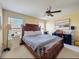 Cozy main bedroom featuring a large bed, ceiling fan, and natural light at 11805 Castine St, New Port Richey, FL 34654