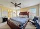 Comfortable main bedroom with ceiling fan, natural light, and en-suite bathroom at 11805 Castine St, New Port Richey, FL 34654