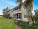 Two-story house with screened porch and balconies surrounded by tropical landscaping at 1181 Burgos Dr # 406, Sarasota, FL 34238