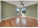 Bedroom featuring hardwood floors, two windows that lets in natural light, and olive painted walls at 1181 Burgos Dr # 406, Sarasota, FL 34238