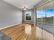 Bedroom featuring hardwood floors, a ceiling fan, a window, and sliding glass doors to a balcony with a view at 1181 Burgos Dr # 406, Sarasota, FL 34238