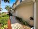 Side view of a two-story home with walkway and well-maintained landscaping at 1181 Burgos Dr # 406, Sarasota, FL 34238