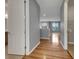 Hallway featuring hardwood floors and gray walls that open into the living room with two windows at 1181 Burgos Dr # 406, Sarasota, FL 34238