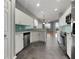 Well-lit kitchen with stainless appliances, tiled backsplash, and a view of the living space at 1181 Burgos Dr # 406, Sarasota, FL 34238