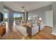 Elegant living room with hardwood floors, neutral paint, and lots of natural light from a large sliding glass door at 1181 Burgos Dr # 406, Sarasota, FL 34238