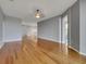 Spacious living room featuring hardwood floors, with gray walls that leads into the hallway and kitchen at 1181 Burgos Dr # 406, Sarasota, FL 34238