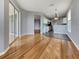 Bright living space with hardwood floors, adjacent kitchen, and sliding glass doors to balcony at 1181 Burgos Dr # 406, Sarasota, FL 34238