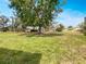 Expansive backyard featuring a large tree and well-manicured lawn, offering a serene outdoor space at 612 Bird Bay S Dr # 113, Venice, FL 34285