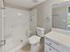 Bathroom featuring a white tile shower, a toilet, a vanity with drawers, and a mirror at 612 Bird Bay S Dr # 113, Venice, FL 34285
