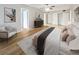 View of a staged main bedroom featuring a ceiling fan, chair, and decor at 612 Bird Bay S Dr # 113, Venice, FL 34285
