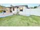 Charming home featuring a stone accent wall, manicured lawn, and inviting entryway at 7517 Blossom Ave, Tampa, FL 33614