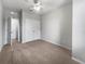 This bedroom features neutral carpet, ceiling fan and a double closet at 8110 Enclave Way # 101, Sarasota, FL 34243