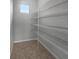 This walk-in closet features tile flooring and wire shelving at 8110 Enclave Way # 101, Sarasota, FL 34243