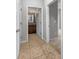 Hallway featuring tile flooring, a bathroom, and bedroom entrance at 8110 Enclave Way # 101, Sarasota, FL 34243