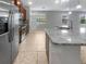 Open kitchen featuring stainless steel appliances, granite countertops, and tile flooring at 8110 Enclave Way # 101, Sarasota, FL 34243
