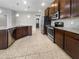 Modern kitchen featuring stainless steel appliances, a breakfast bar, and dark cabinetry at 8110 Enclave Way # 101, Sarasota, FL 34243