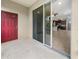 Covered patio with red door and sliding glass doors, offering an indoor-outdoor flow at 8110 Enclave Way # 101, Sarasota, FL 34243