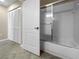 Bathroom featuring an open door, tile flooring, closet with louvred doors and glass shower at 6507 Stone River Rd # 310, Bradenton, FL 34203