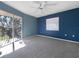 This bedroom features a ceiling fan, private balcony, plush carpet and a window at 6507 Stone River Rd # 310, Bradenton, FL 34203