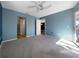 Bedroom features plush carpet, light blue walls, and access to a private balcony at 6507 Stone River Rd # 310, Bradenton, FL 34203