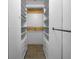 Organized walk-in closet with white shelves, drawers, and hanging rods at 6507 Stone River Rd # 310, Bradenton, FL 34203