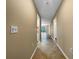 Hallway with tan walls, light switch, outlets, tile flooring, and natural light streaming in at 6507 Stone River Rd # 310, Bradenton, FL 34203