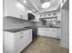 Well-lit kitchen with white cabinets, modern appliances, and a tiled floor, offering a clean and functional space at 6507 Stone River Rd # 310, Bradenton, FL 34203