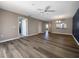 Spacious open-plan living room with wood flooring, ceiling fan, and neutral walls offers versatile design options at 6507 Stone River Rd # 310, Bradenton, FL 34203
