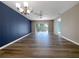 Light-filled living room with wood-style flooring, ceiling fan, and sliding glass doors to the outdoor area at 6507 Stone River Rd # 310, Bradenton, FL 34203